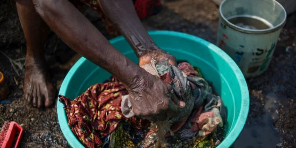 一位住在北基伍省收容營內的女性正在清洗衣物。