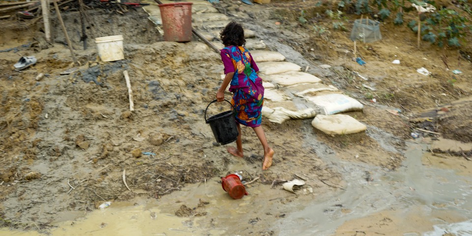 羅興亞女孩在傾盆大雨來臨前，提著水回帳篷。 ©Dalila Mahdawi/MSF